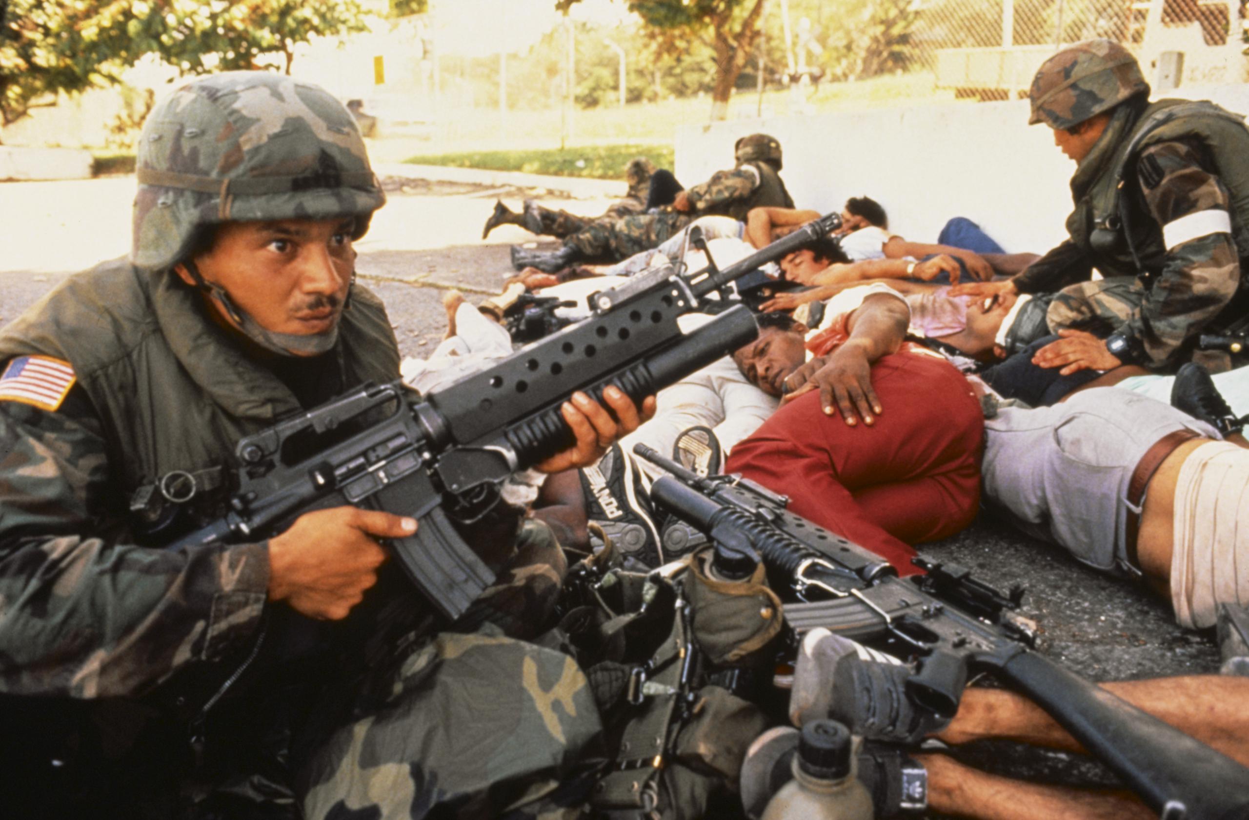 us troops taking cover with civvies in grenada.jpg