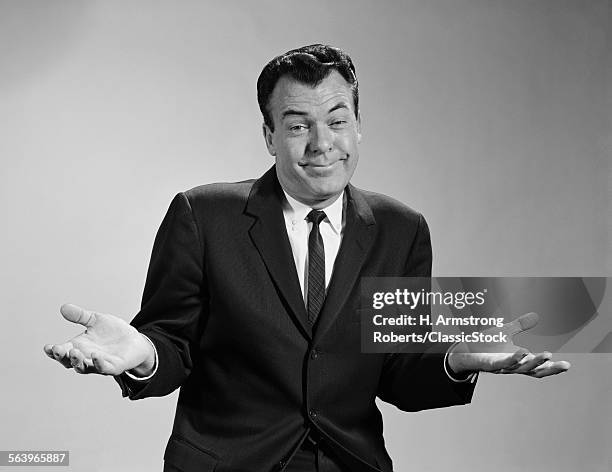 1960s-business-man-shrugging-his-shoulders-looking-at-camera.jpg